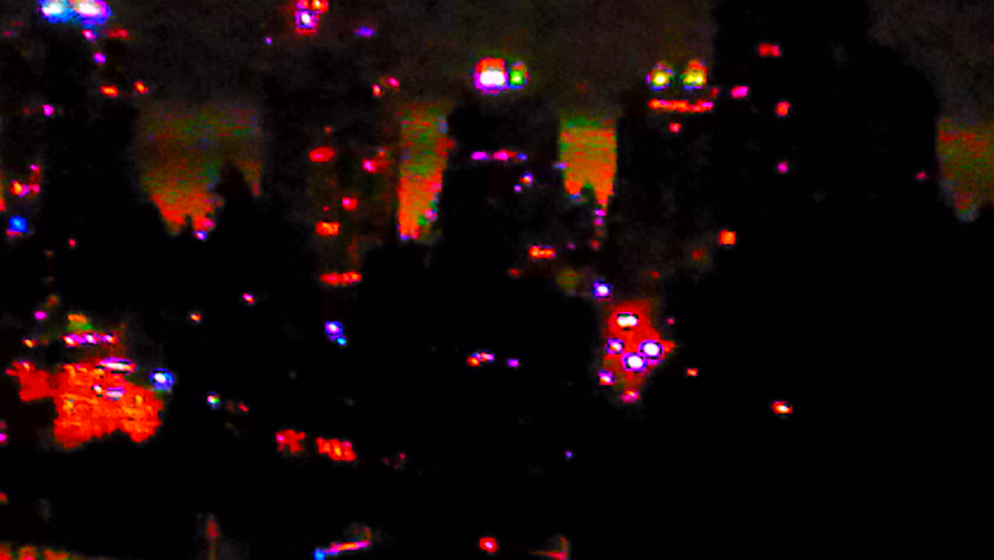 This picture I took from Mike's balcony at about two in the morning. I used the wrong setting. The clumps of red between buildings is actually fog.