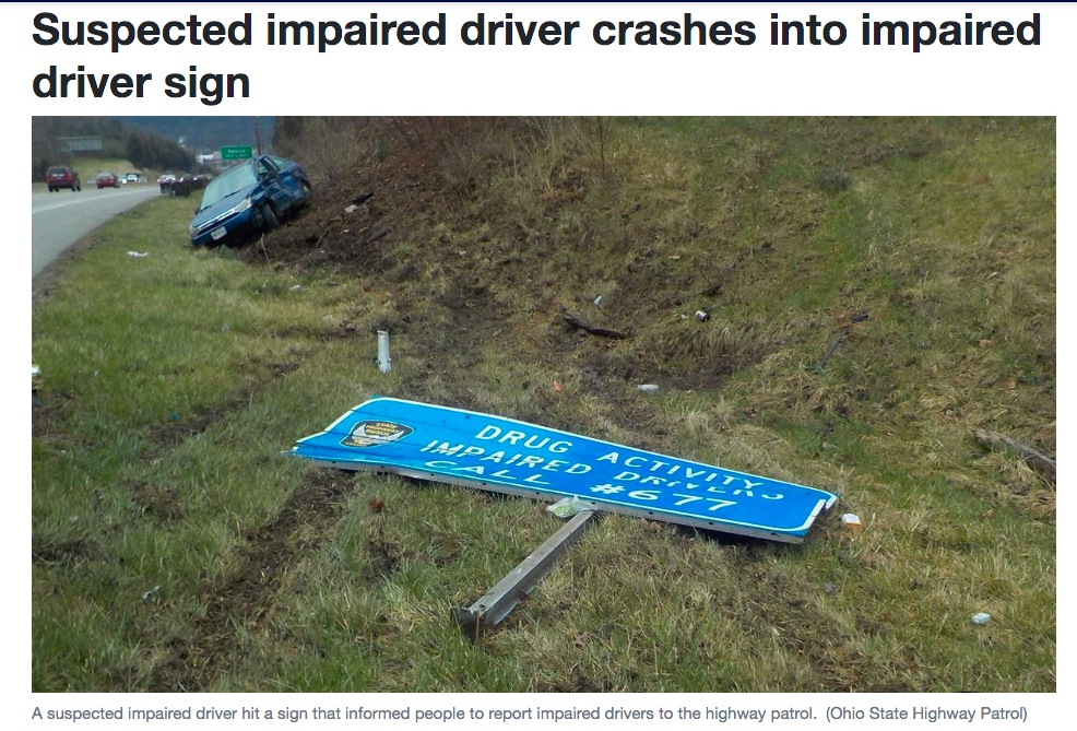 flattened 'report drunk driving sign' next to the backwards facing sedan that hit it.