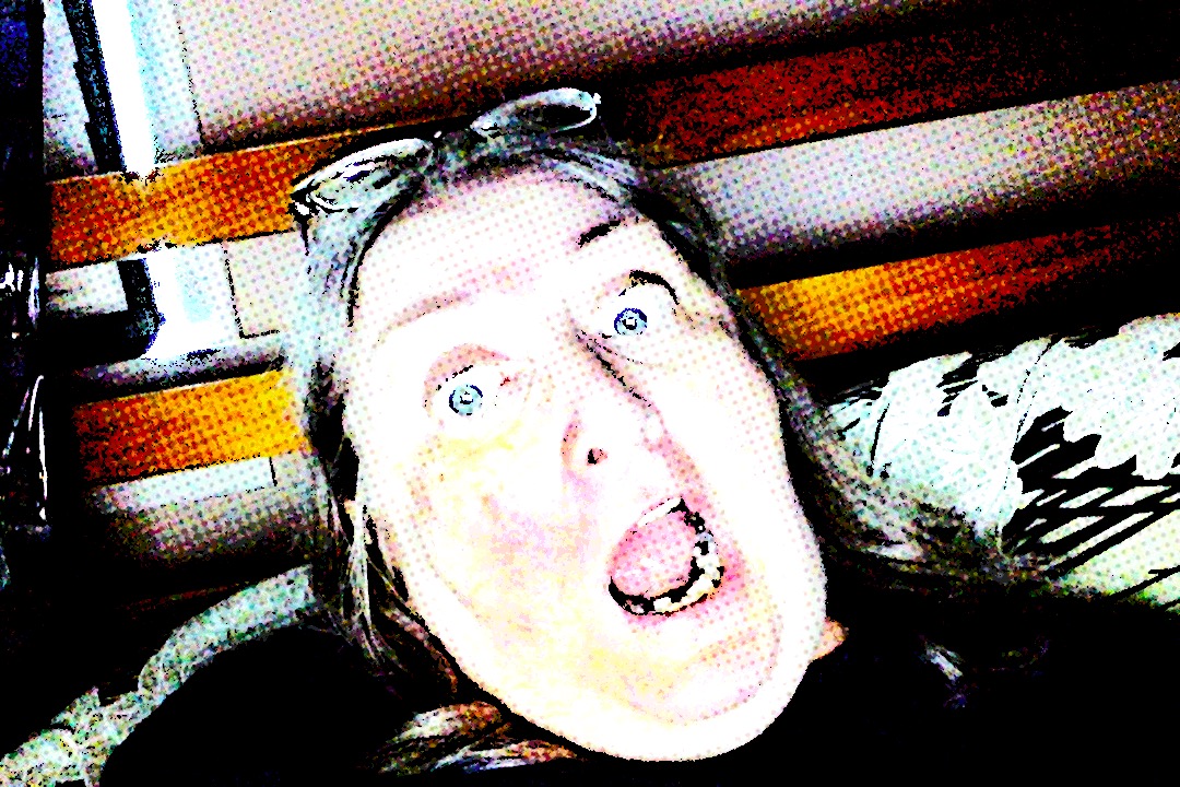 Comic book effect applied to a photo of allegra sloman, a middle aged white woman, showing extreme levels of astonishment and virtually all of her teeth