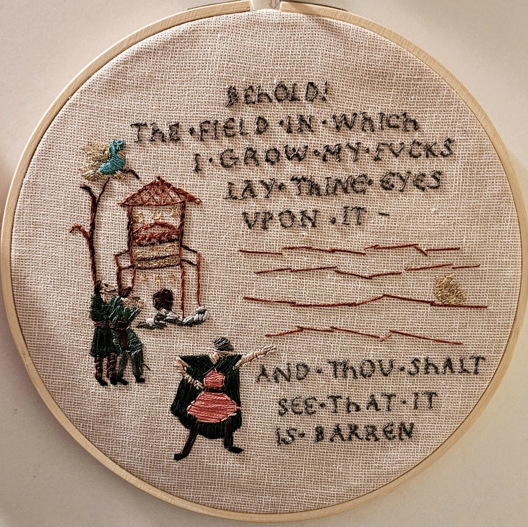 Circular needlework showing Bayeux tapestry style characters and buildings, and in Bayeux style lettering says Behold the field in which I grow my fucks lay thine eyes upon it - and thou shalt see that it is barren